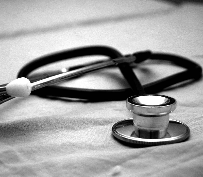 A patient speaking with a doctor in a bright clinic